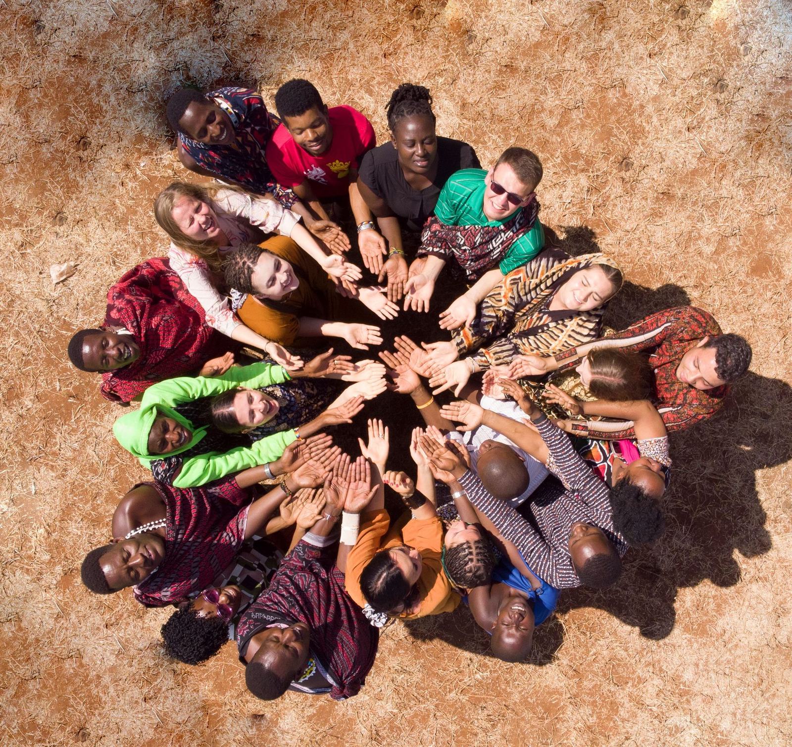 Community members and volunteers joining hands together in partnership