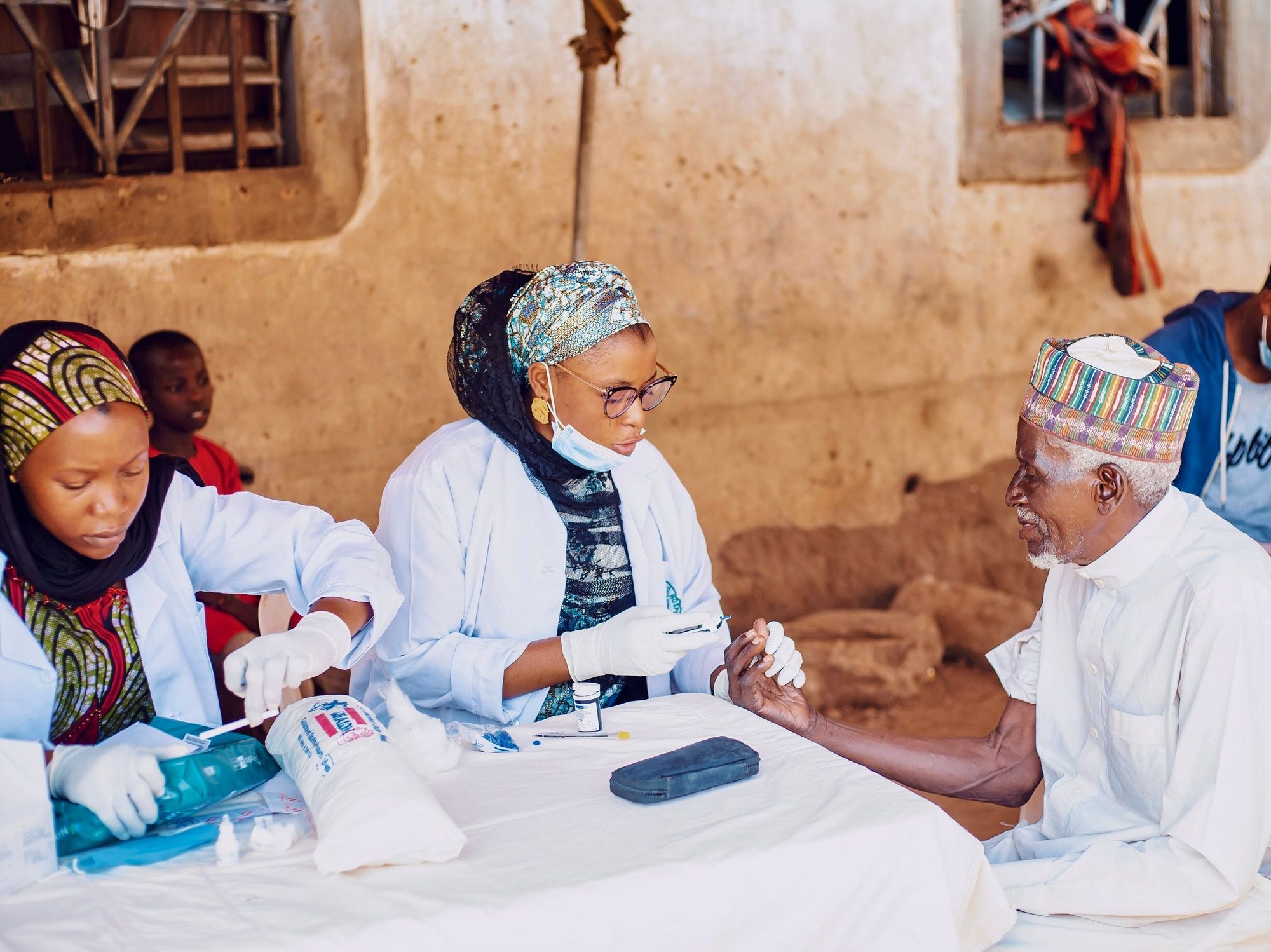 Outreach team members walking through a community during a field visit