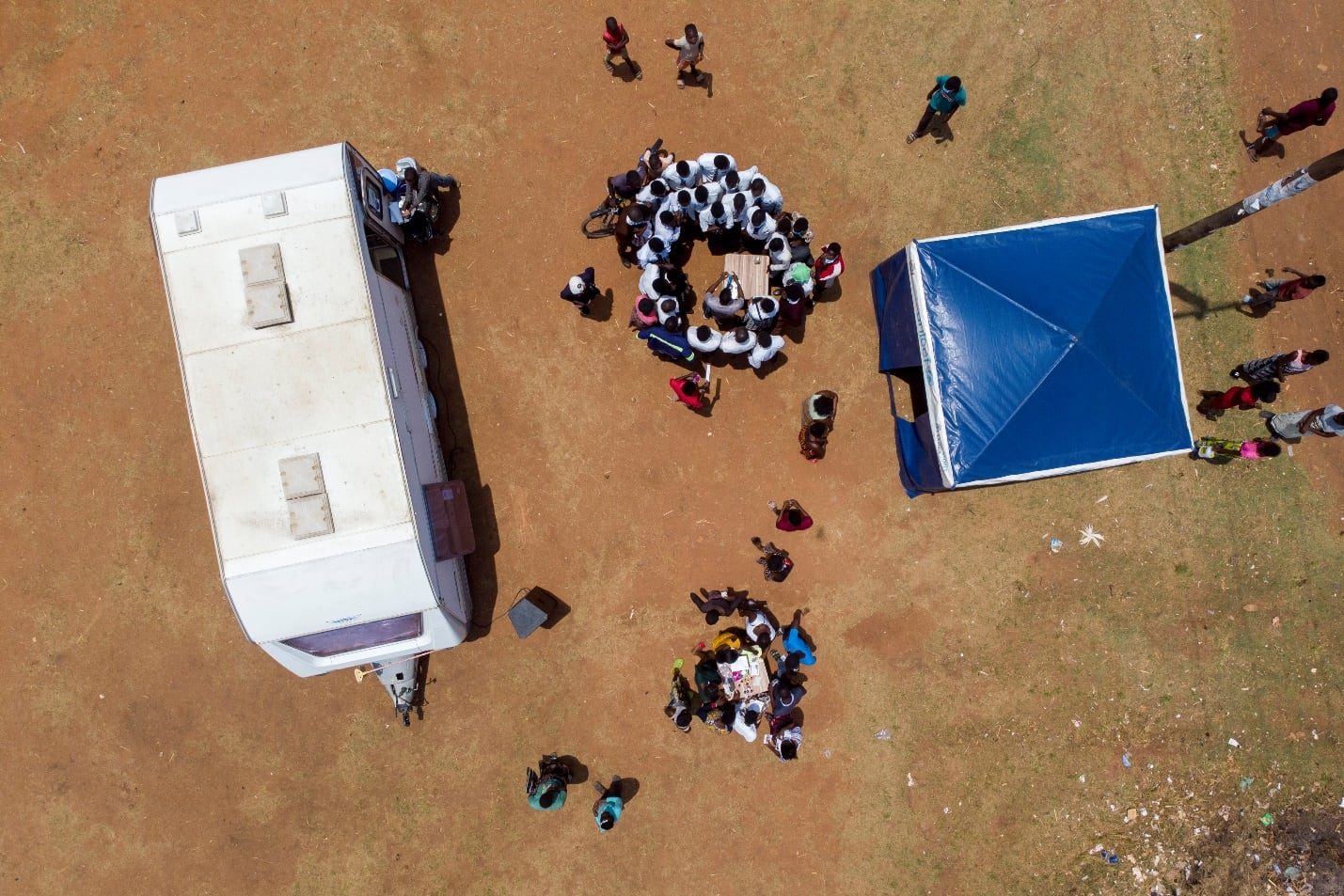 Aerial view of a mobile screening unit and outreach tent set up in a community